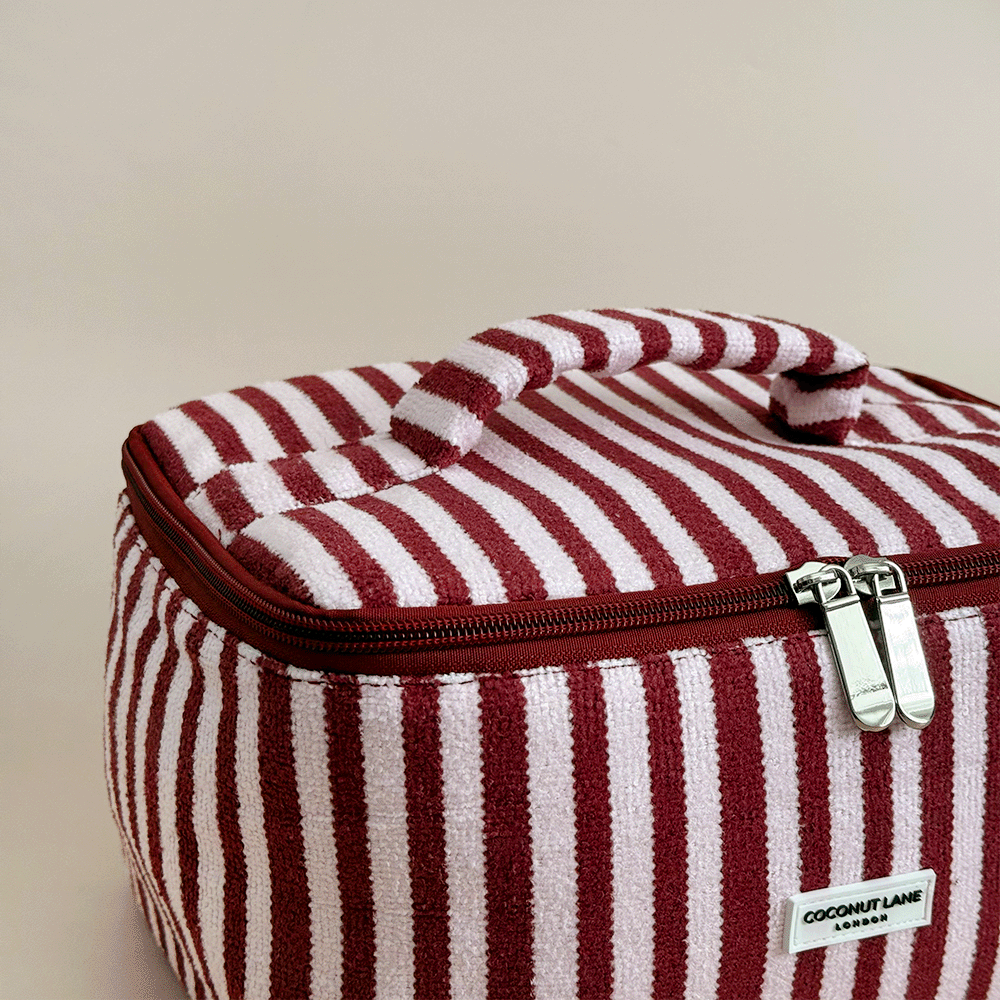 Burgundy and light pink striped Vanity Case, with handle, silver zip and Coconut Lane logo badge.