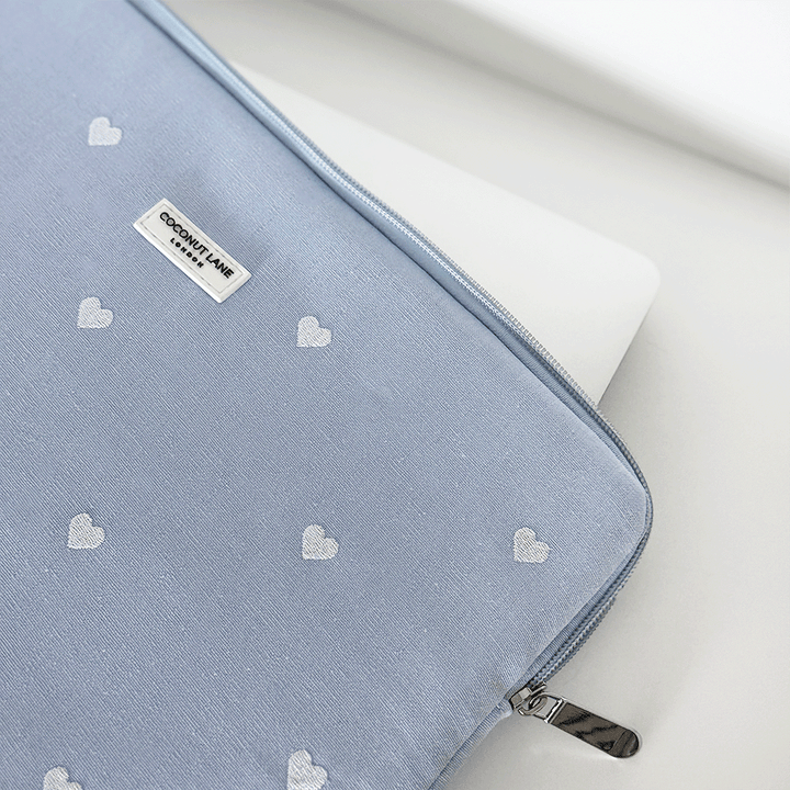 Blue fabric Laptop Sleeve with embroidered heart design.