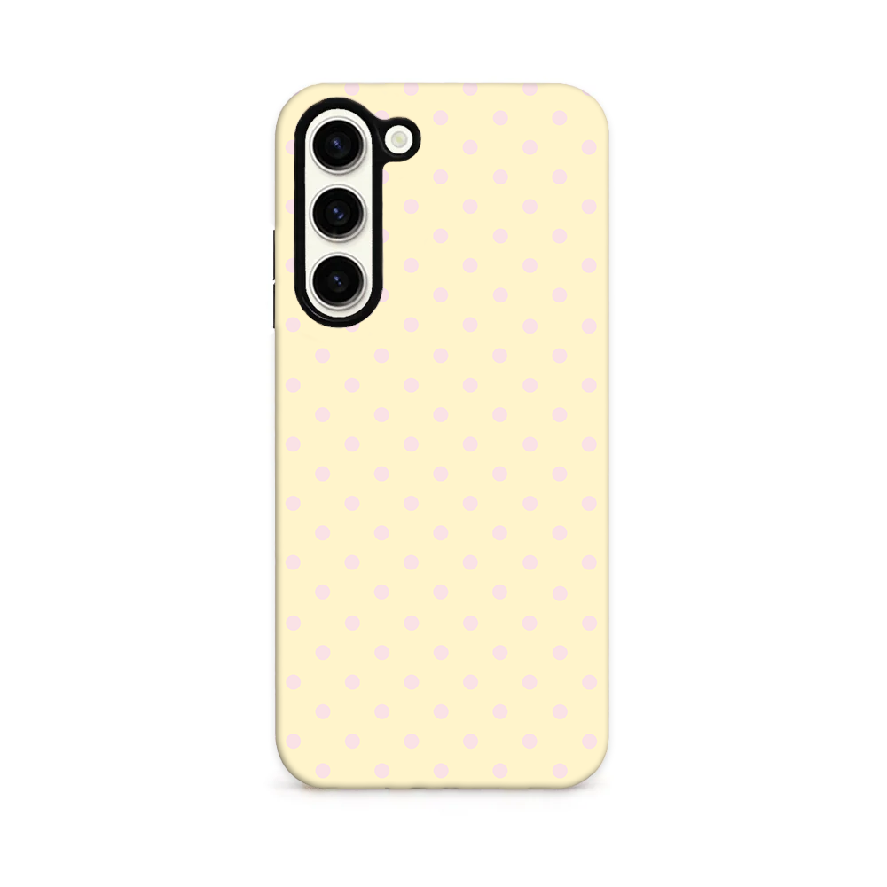 A pale yellow phone case with a repeating pattern of small light pink polka dots.