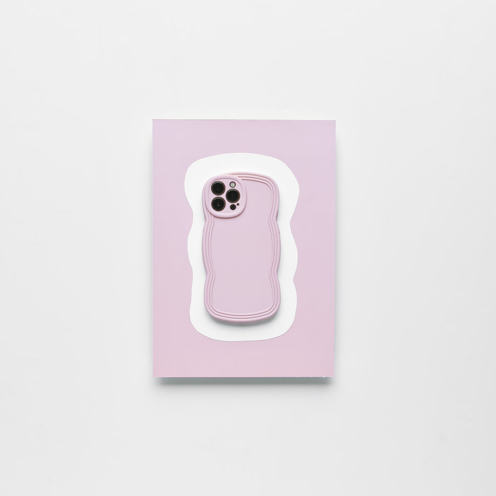 A smartphone with a Blueberry protective case from Coconut Lane lies on top of a light pink and white wavy-edged mat against a plain white background. The lightweight NAKD Curvy Phone Case highlights the phone camera cutout, making it both stylish and functional.
