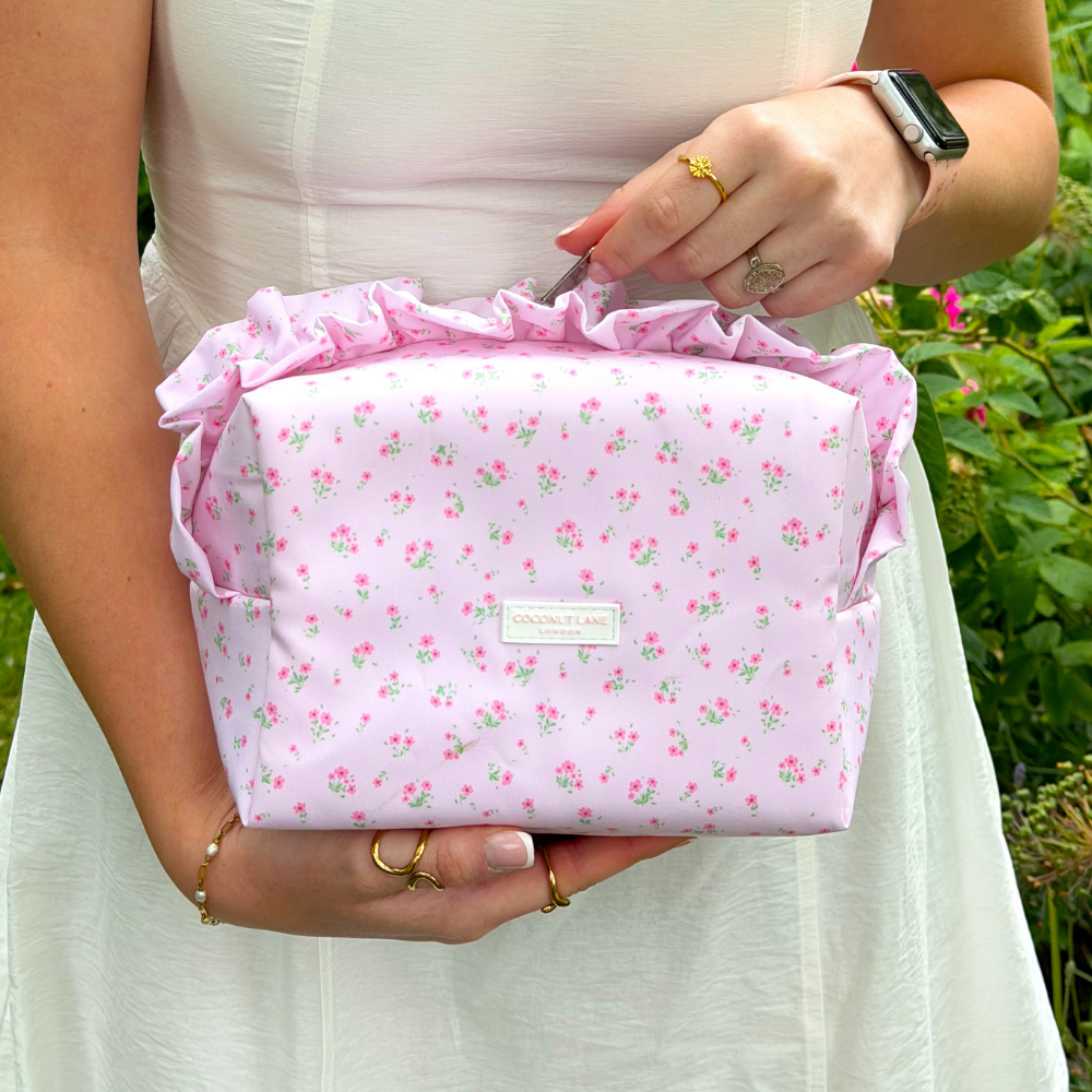 Girl holding Ditsy Floral Pink Ruffles Makeup Bag