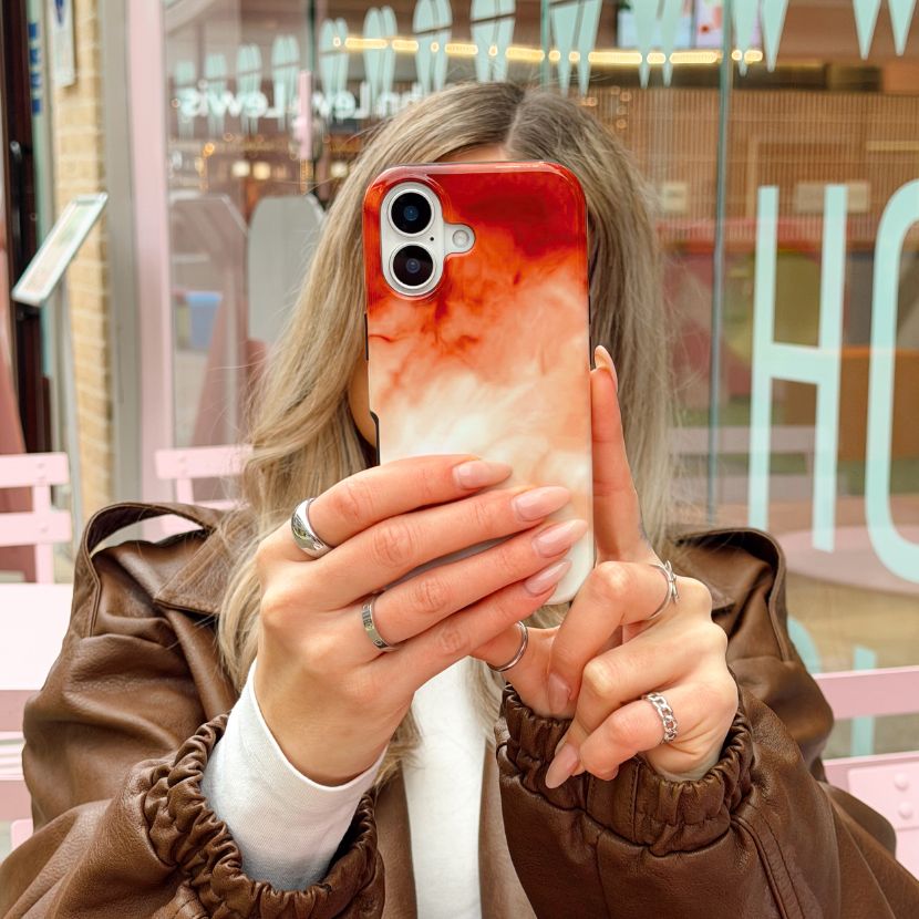 Girl in a brown jacket at a cafe taking a selfie with Iced Latte Tough Phone Case