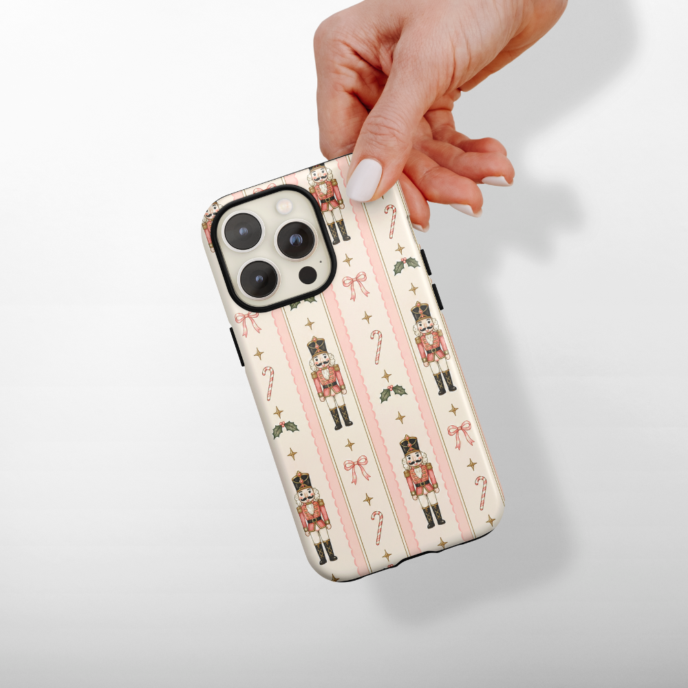 Cute nutcracker, candy cane, bows and sparkles case with pink stripes.