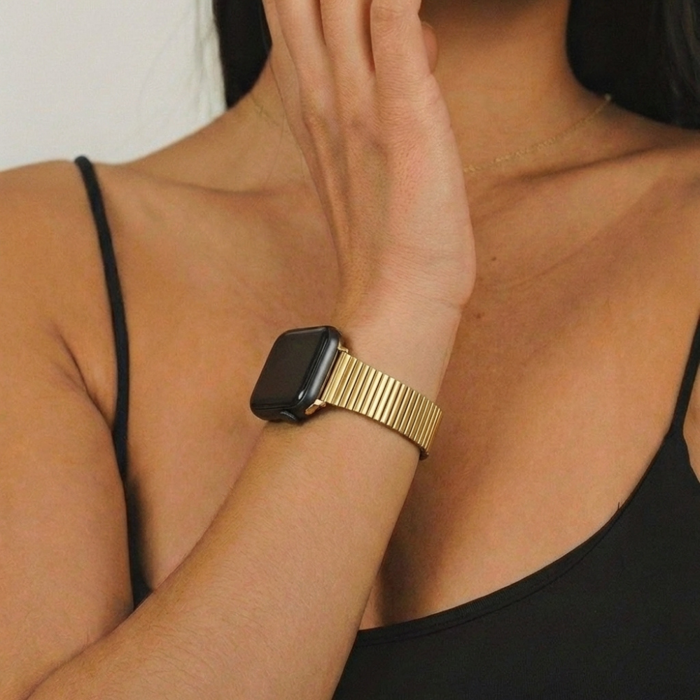 Model girl posting wearing black top and showing off the Slim Fine Line Watch Strap in Gold