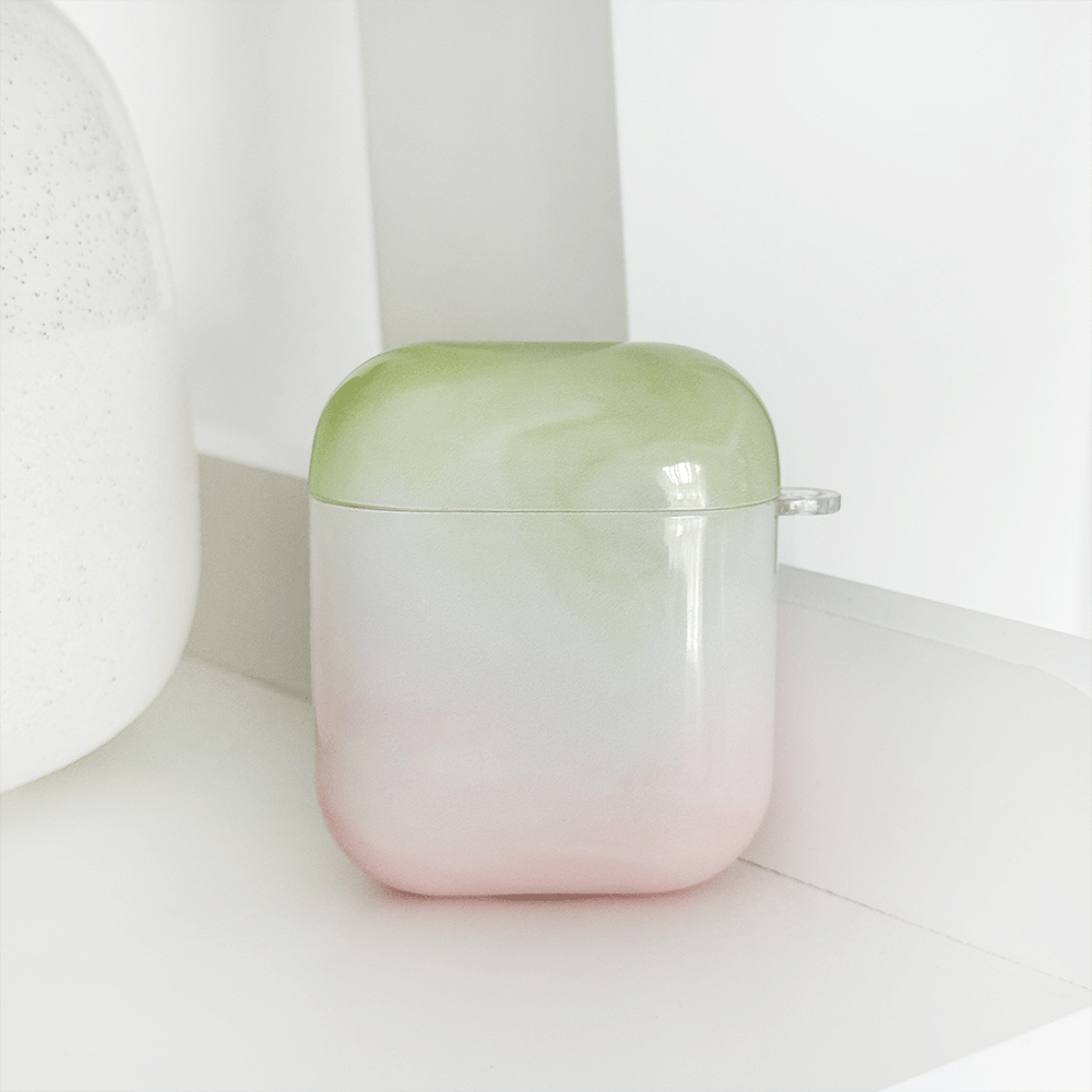 Green and pink ombre effect AirPods Case. Colour fades from green at the top into white, into pink. 