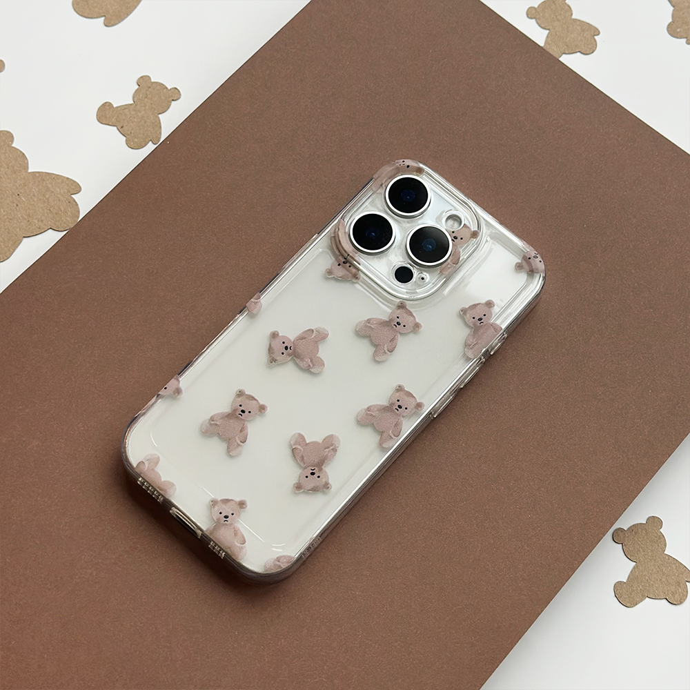 Clear phone case with small 3D bear accents, displayed on a teddy bear patterned background.