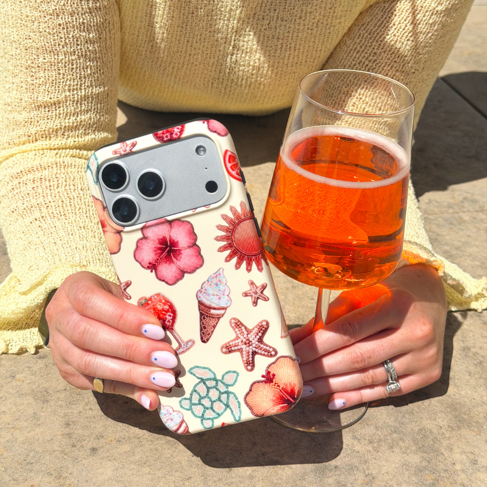 Close up of Tough Island Girl Phone Case next to aperol spritz