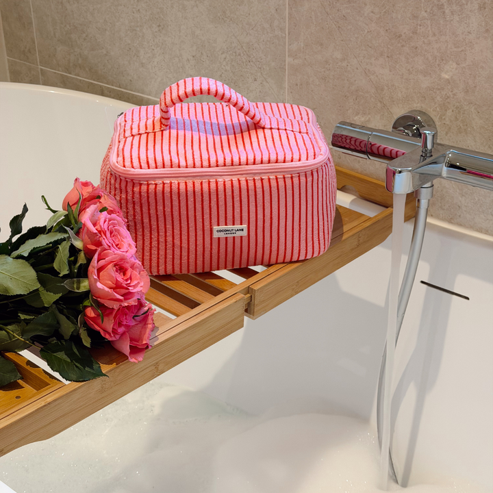Cherry Stripes Vanity Case in a bath setting next to roses