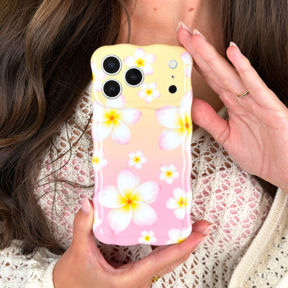 Phone case with floral design held by a person