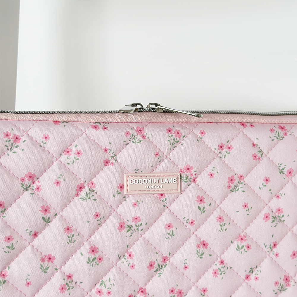 Pink quilted laptop sleeve with ditsy floral pattern from Coconut Lane.