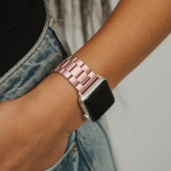 Girl with hand in jean pocket wearing stainless steel watch strap in blush