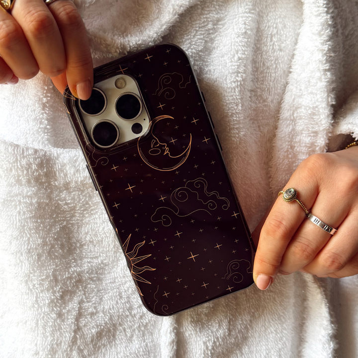 Girl in white dressing gown holding tough magsafe celestial phone case